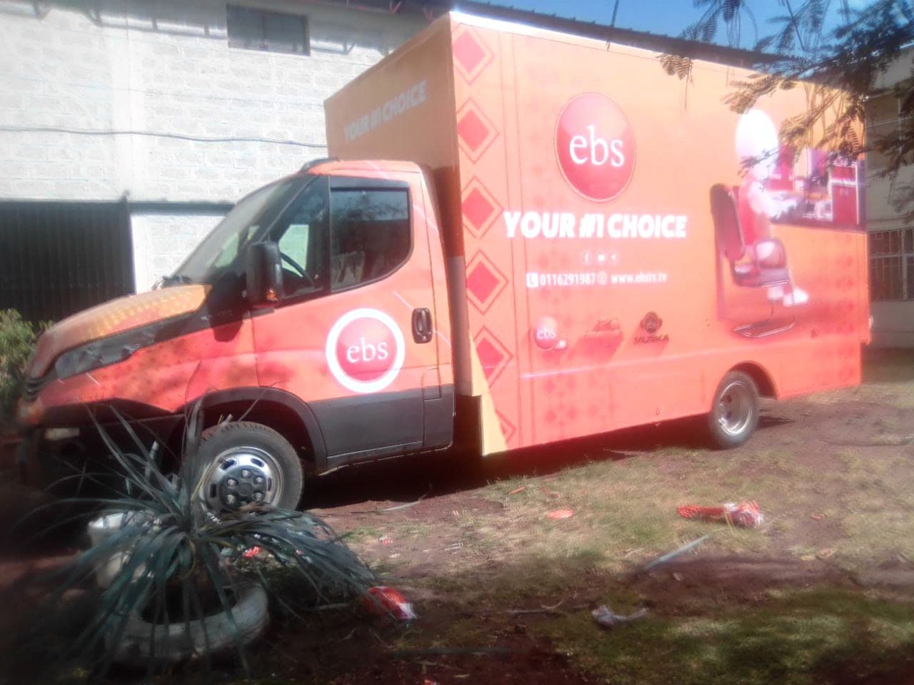 Orange EBS television outside-broadcast truck wrapped on the cab and box with the "Your #1 Choice" campaign
