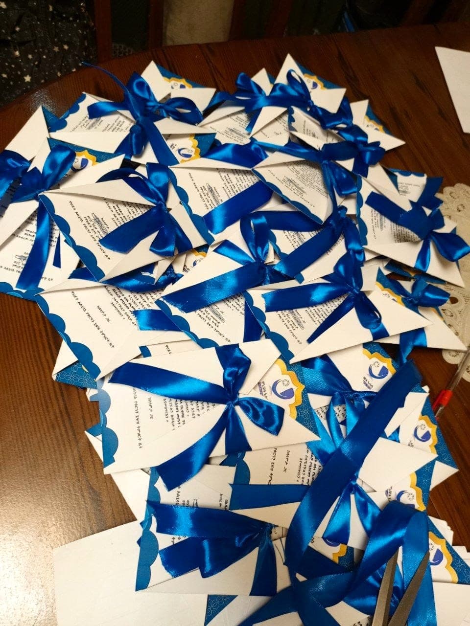 Stack of invitation cards finished with blue satin ribbon