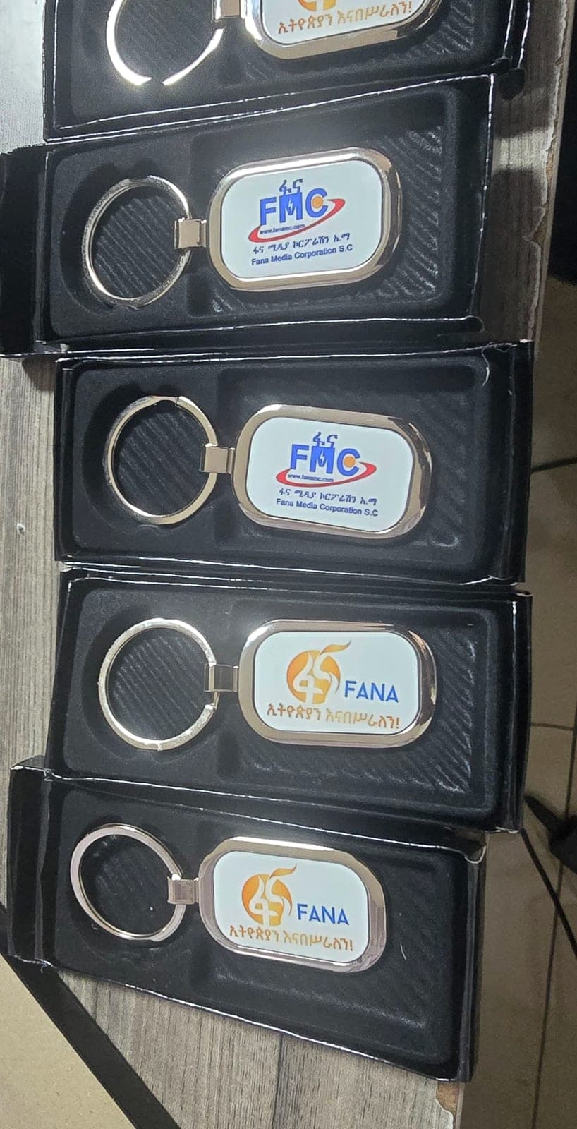 Metal keychains branded for Fana and FMC, presented in individual gift boxes