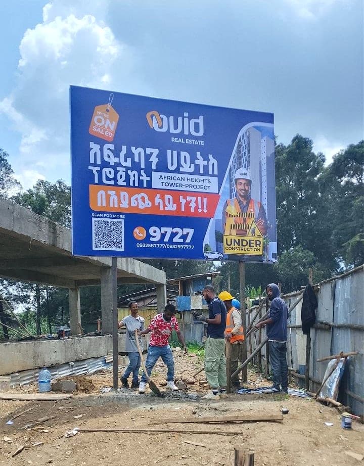 Ovid Real Estate billboard for the African Heights Tower project being erected on a construction site